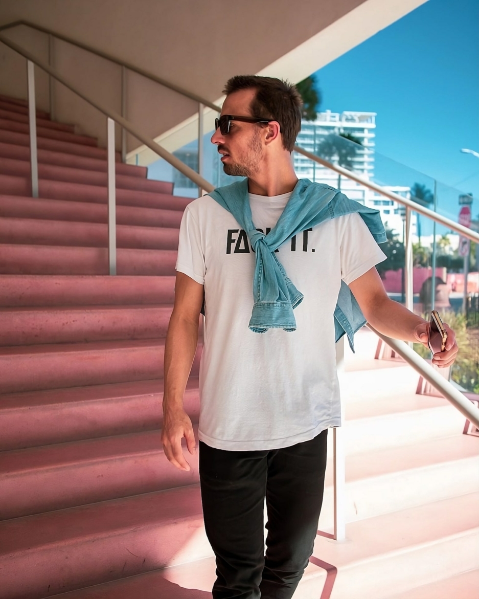 Model Wearing White Fack It T-Shirt Outside on Sunny Stairs