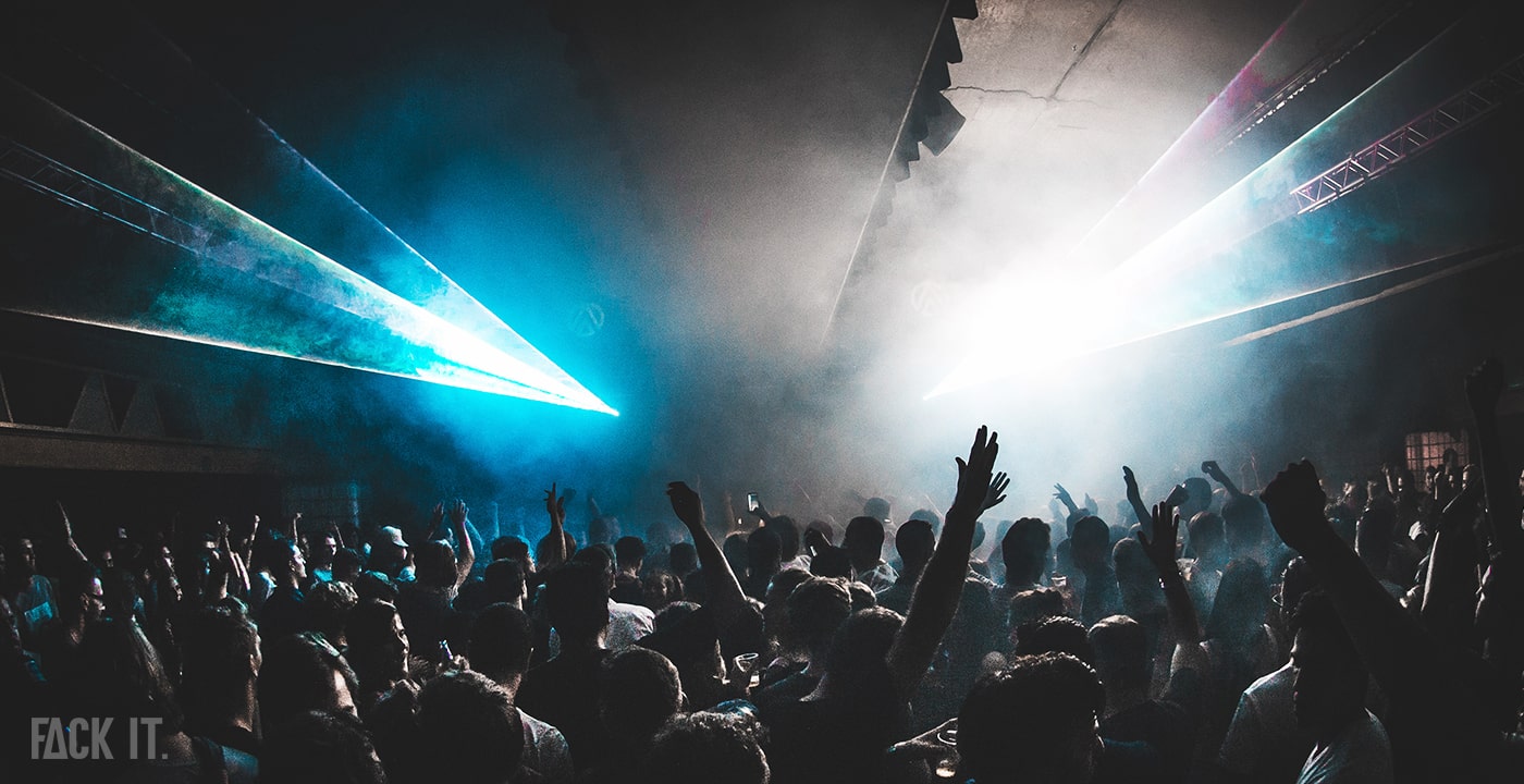 Inside Club Fuse Brussels: A packed crowd dances energetically to techno music, surrounded by vibrant lights and an electrifying atmosphere.