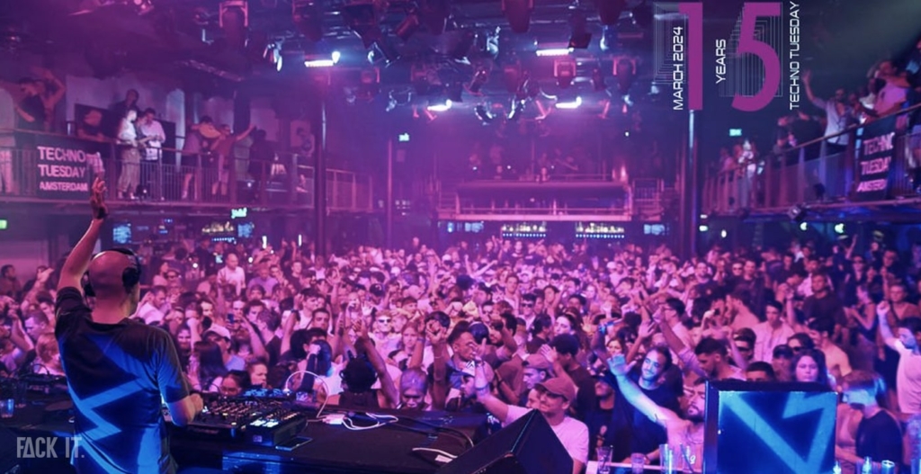 A large, iconic venue with a spacious dance floor, vibrant lighting, and a crowd immersed in high-energy techno beats.