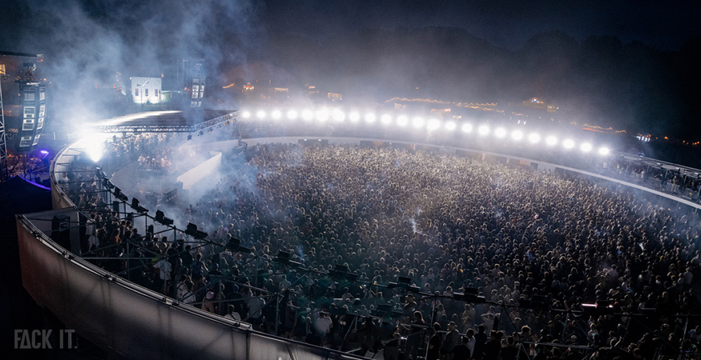 Crowd dancing at Dekmantel Festival 2025, one of the biggest techno raves in the Netherlands, with a vibrant stage and light show.