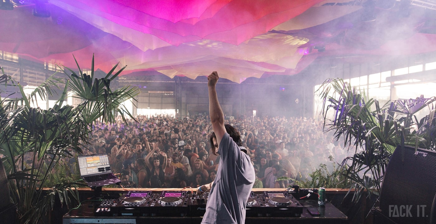 Paradigm Festival 2025: A lively crowd enjoys a daytime techno set under open skies, with colorful stage designs and a vibrant festival atmosphere in Groningen.