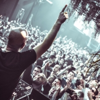 A futuristic club scene with deep, immersive lighting, a packed dance floor, and a DJ controlling the pulse of a forward-thinking techno crowd.