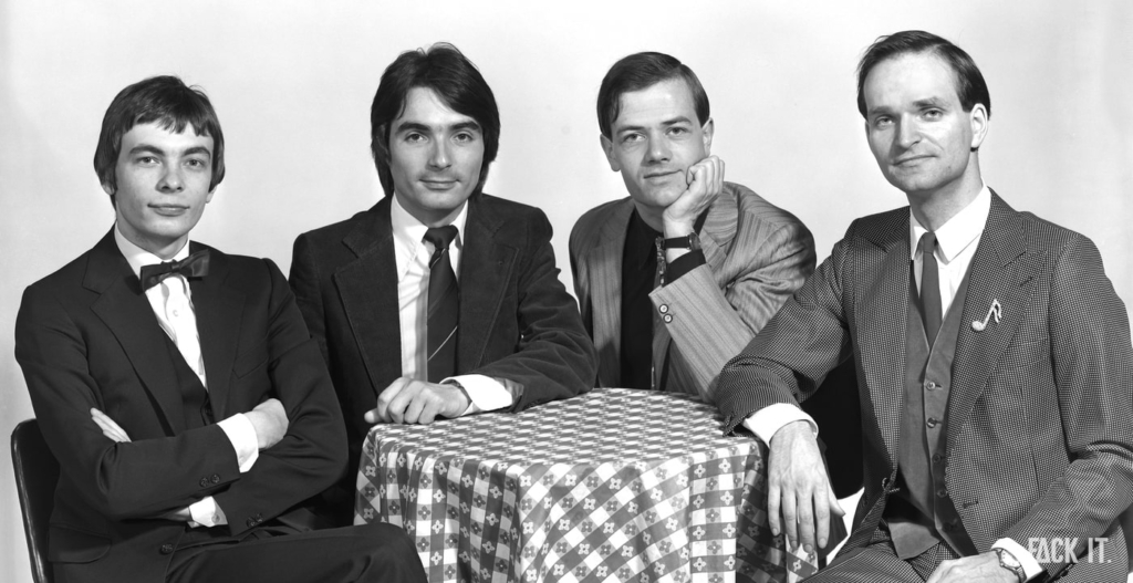 A high-definition black-and-white photo of Kraftwerk, showing the group clearly with their signature futuristic aesthetic.